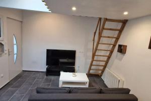 a living room with a couch and a table at Résidence ROZ 2 in Antony