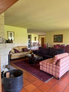 a living room with two couches and a couch at Quinta da Ponte in Resende