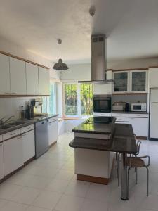 a kitchen with white cabinets and a black counter top at Quinta da Ponte in Resende