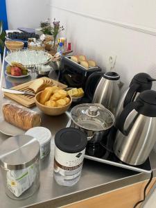 a kitchen counter with food and appliances on it at Cit'Hôtel du Parc in Carrières-sous-Poissy