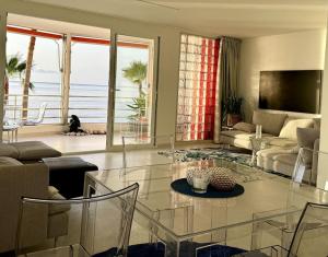 a living room with a glass table and a living room at Beachfront, First line, 2-Bdr,2-Bath, Swiming Pool in Albir