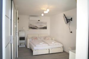 Götzendorf an der LeithaEco Overnight Inn - Self Check-in的一间白色的小卧室,内有一张床