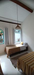 Postel nebo postele na pokoji v ubytování Vila Rita Hostel Arraial d'Ajuda