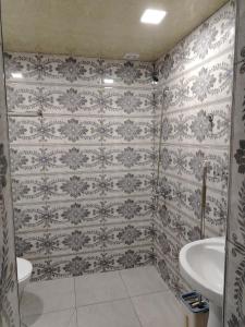a bathroom with a toilet and a sink at Guest House in Garni