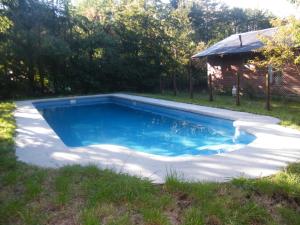 a swimming pool in a yard with a house at Hostal Quillelhue in Pucón