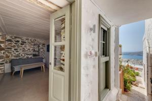 a door to a room with a view of the ocean at Artdecosyros Junior in Ano Syros