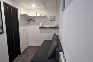 a living room with a couch and a shelf at Résidence ROZ 3 in Massy
