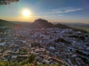 a view of a city with a castle on the hill at VILLA ROBLES in Santisteban del Puerto