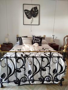 a bedroom with a black and white bed with pillows at VILLA ROBLES in Santisteban del Puerto