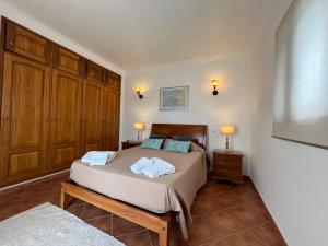 a bedroom with a bed with two pillows on it at Villa Balsa in Tavira +37 photos