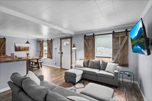 a living room with a couch and a table at Close to Hiawatha Tr and Biking with HOT TUB in Wallace