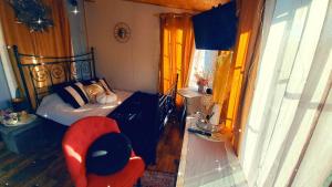 a bedroom with a bed and a red chair at DAGNA summer house in Šunupis