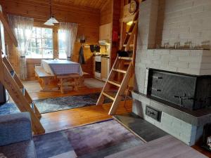 a living room with a fireplace and a table at Hillatupa in Kolari