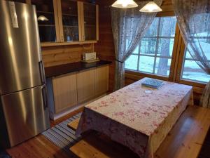 a kitchen with a table and a refrigerator at Hillatupa in Kolari