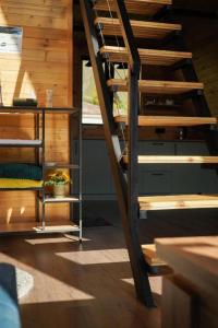 a wooden staircase in a room with a window at Pyramid Home Kazbegi in Stepantsminda +10 photos