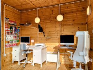 a room with two computer desks and two monitors at Stairway to Devon in High Bickington