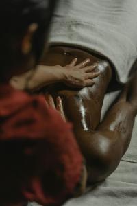 a person laying on a bed with their hands on a pillow at Airio Athens Suites in Athens