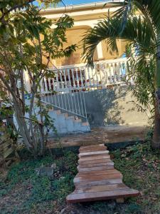 a set of wooden steps in front of a house at La Jéméli in Grand-Bourg
