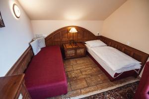 Voodi või voodid majutusasutuse Šumava Inn toas