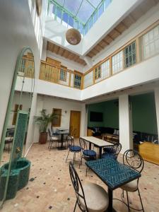 an empty room with tables and chairs in a building at Riad Madinina in Marrakesh
