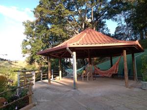 a wooden gazebo with a hammock under it at Pousada Santa Martha - Suíte Quíntupla - Entre Rios de Minas - MG in João Ribeiro +9 photos