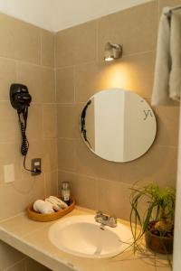 a bathroom with a sink and a mirror at Hospedaje Boutique Paz Creativa in San Cristóbal de Las Casas +43 photos