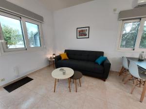 a living room with a couch and a table at Oresti's House in Loutraki +2 photos