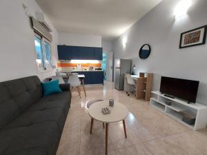 a living room with a couch and a table at Oresti's House in Loutraki