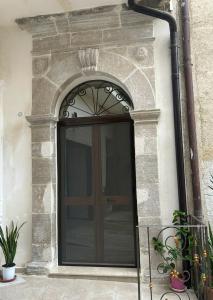 a large glass door in a stone building at B&B Heracleae Luxury Home in Cattolica Eraclea
