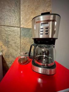 a blender sitting on top of a red counter at Cabañas San Pedro de Atacama. in San Pedro de Atacama +26 photos