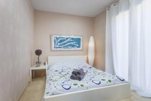 a bedroom with a bed with a stuffed animal on it at Arenyslux II in Arenys de Mar