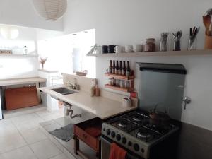 a kitchen with a stove and a counter top at Casa bohé Casilda in Casilda +6 photos
