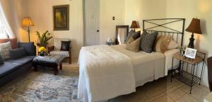 a bedroom with a large bed and a couch at Cerca de Aeropuerto , bleseed house in Monte Adentro