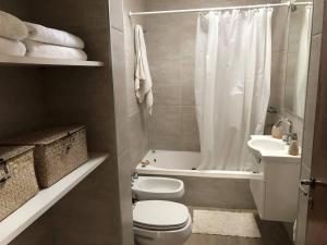 a bathroom with a toilet and a sink and a shower at Casa bohé Casilda in Casilda