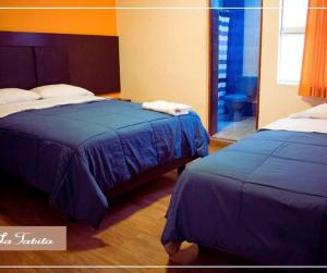Postel nebo postele na pokoji v ubytování Hostal POSADA LA TABITA