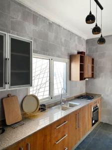 a kitchen with a sink and a counter top at La Villa Goyave - Moderne & Spacieux 2 chambres in Pointe-Noire
