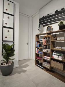 a room with a book shelf with books and a plant at 216-Koi living Ballito in Ballito