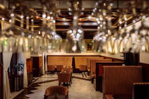 a dining room with chairs and chandeliers at Hotel Most Slávy in Martinske Hole