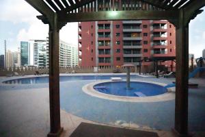 una piscina con gazebo di fronte a un edificio di Nomad Partition Room in Barsha Heights 3 mins to ICM Metro a Dubai
