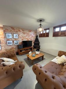 a living room with two couches and a coffee table at Casa Tramonto in Lavras Novas