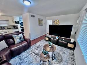 a living room with a couch and a flat screen tv at Comfortable 3BR Close to All in Dayton
