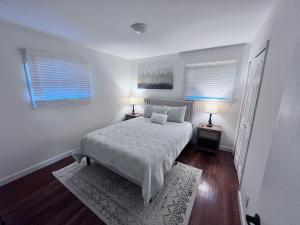 a bedroom with a bed with two night stands and two lamps at Comfortable 3BR Close to All in Dayton