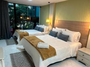 Postel nebo postele na pokoji v ubytování Provenza Medellin Hotel Boutique + 37 fotografií