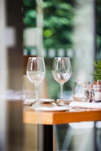three wine glasses sitting on top of a table at Lanes Hotel in Yeovil +9 photos