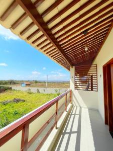 a balcony of a house with a wooden roof at Nosso Chalé in Serra de São Bento