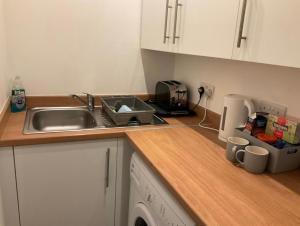 a kitchen with a sink and a counter top at 103 NELSON STREET Hailey in Largs +11 photos