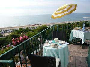 a table and chairs on a balcony overlooking the ocean at Villa Gabriella B&B - Apartments in Venice-Lido