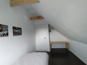 a bedroom with a bed and a table in a attic at De Heide in Wijnjewoude