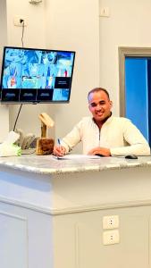 a man sitting at a desk with at The Home Siwa ذا هوم سيوة in Siwa