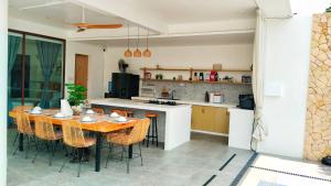 a kitchen and dining room with a table and chairs at Villa Silana in Moalboal